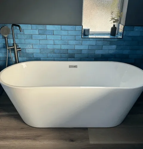 Freestanding bath with floor-standing mixer and blue metro tiles